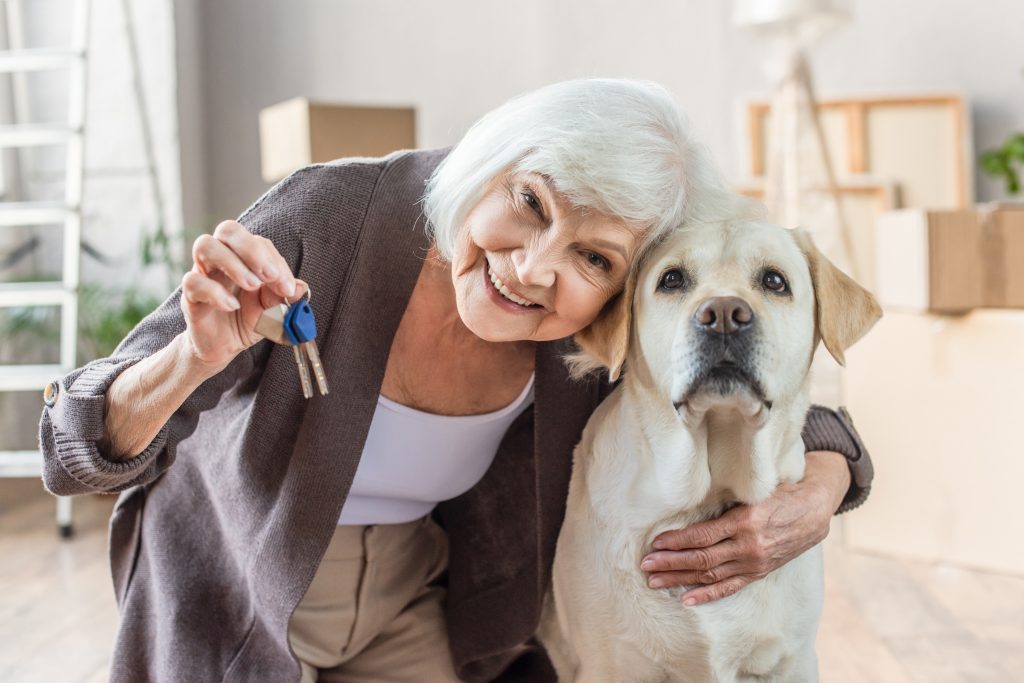 crello 413938374 stock photo smiling senior woman embracing dog scaled
